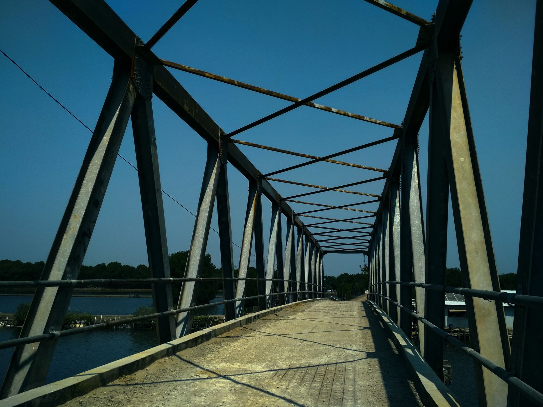 rusty iron bridge across river